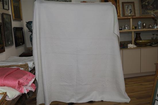 An off-white quilt with blue stitching, a reversible blue and cream quilt, a creamy oyster quilt and a mint green quilt (4)
